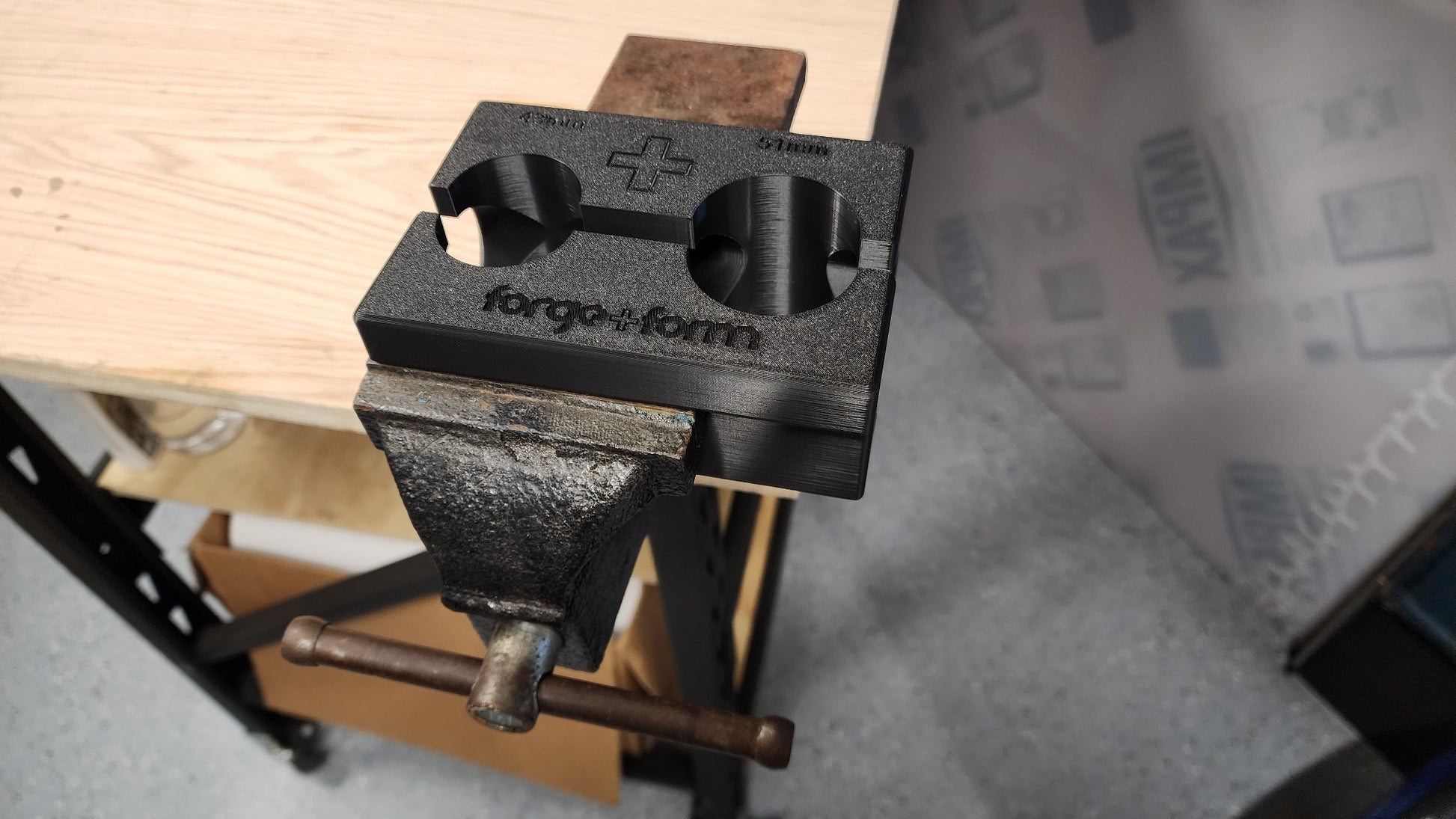 Fork servicing clamp fitted to motorcycle fork upper leg in bench vice